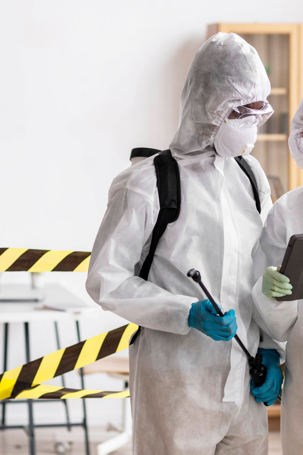 two people in hazmat suits and clipboardsq