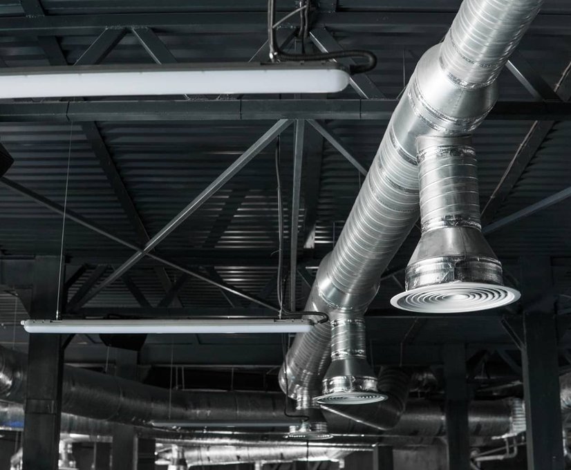 woman in light brown attire sitting on a floor with her air ourifier